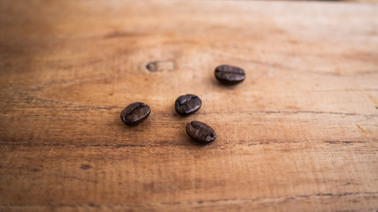 dark rose coffee bean, Black coffee cup on old wooden table top view.