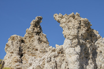 rough rock formation against a blue sky