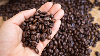 dark rose coffee bean, Black coffee cup on old wooden table top view.