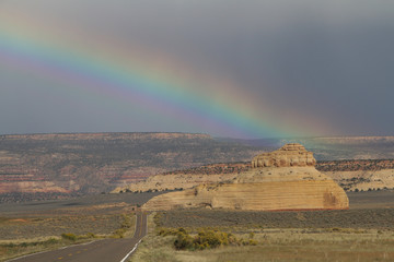  motorway to a desolate mountain landscape with a rainbow