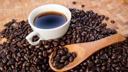 dark rose coffee bean, Black coffee cup on old wooden table top view.