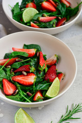 Restaurant food delivery lunch at home. Fitness food strawberry and  spinach salad. dish for spring and summer menu business lunch. selective focus.