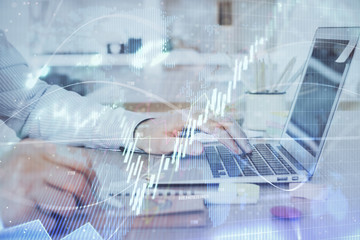 Multi exposure of stock market chart with man working on computer on background. Concept of...
