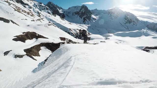 man doing a trick on skis with a beautiful mountain backdrop in the french alps Europe