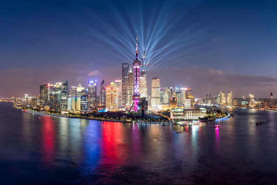 Pudong skyline lightshow at night with Oriental Pearl Tower, Shanghai, China