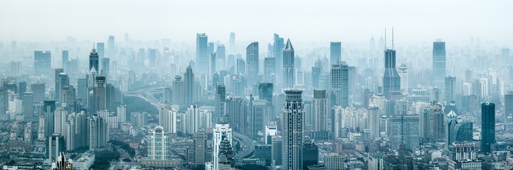 Panoramic view of the Shanghai skyline with skyscrapers covered in smog, China