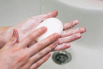 Fototapeta premium Hand washing with soap and water. Foaming hand soap for the prevention of coronavirus. Cleansing the skin of bacteria and other viruses.