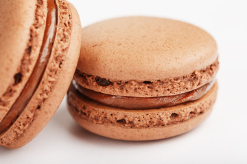Chocolate macaroni cookies on a white background with brown filling, isolated.