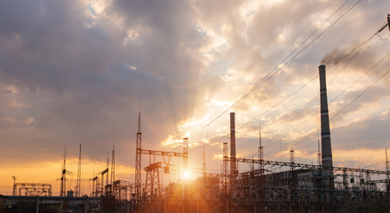 Thermal power stations and power lines during sunset.