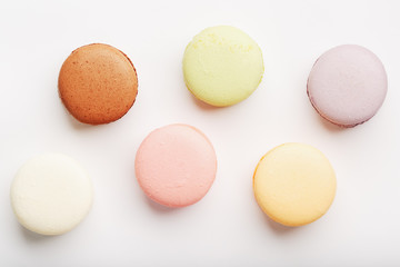 Macaroni cookies of different colors on a white background, isolate.