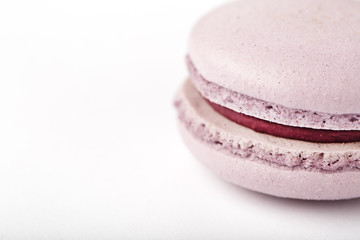 Lilac cookies macaroni on a white background of brown color with filling, isolated.