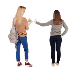Back view of two pointing girl in sweater.