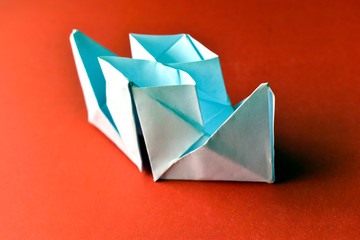 Paper boat with pipes on a red background