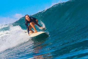 Female surfer on a blue wave - 331425053