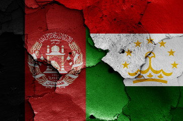 flags of Afghanistan and Tajikistan painted on cracked wall