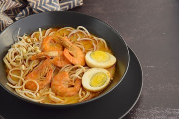 Laksa noodle soup with prawn, egg and bean sprouts