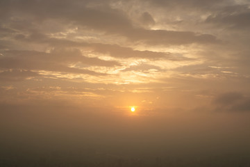 Beautiful sunset scene above the building, orange light and the mist cover all over the city