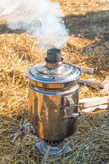 samovar in nature with smoke