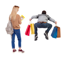 back view of couple with shopping bags.