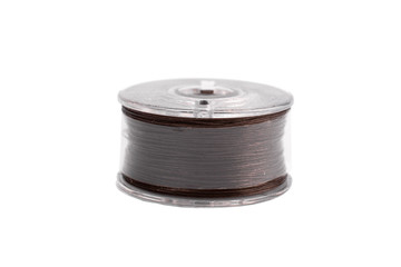A spool of thread from a sewing machine on a white background isolated
