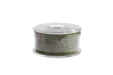 A spool of thread from a sewing machine on a white background isolated