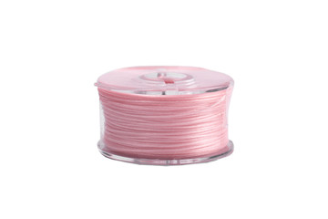 A spool of thread from a sewing machine on a white background isolated