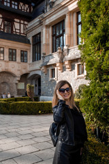 Fototapeta na wymiar Beautiful young woman portrait with sunglasses. Old Castel in the background