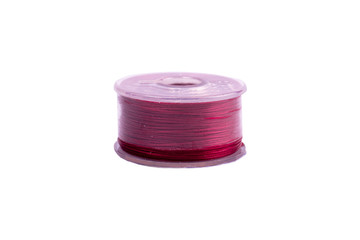 A spool of thread from a sewing machine on a white background isolated