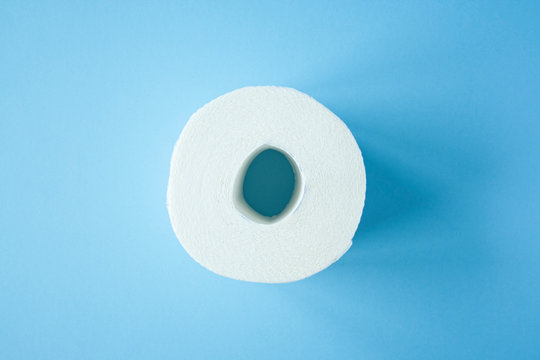 Toilet paper roll on a blue background top view. Toilet paper purchase due to kronavirus concept. Personal hygiene and stopping the spread of the virus. Cleanliness, Hygiene, Sterility