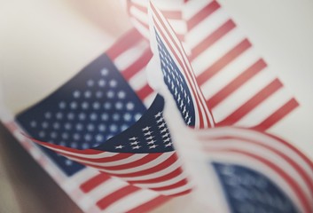 Row of small identical American flags, decorative for themes of summer, pride, Americana, USA flag concept, god bless America.