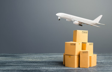 Cardboard boxes and freight airplane. International delivery distribution of goods and products....
