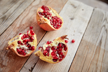 ripe organic pomegranate on teh wooden background