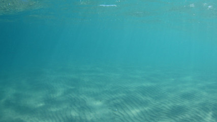 Underwater background photo in clear turquoise blue ocean