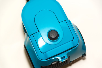 bagless vacuum cleaner in blue stands on a white background