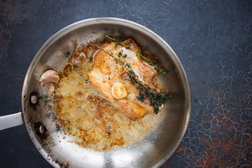 Cooking, Pork Steak with Thyme in a Metal Pan, Close up on dark background