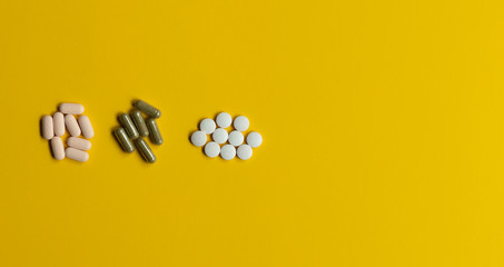three types pills on the yellow background with copy space