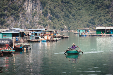 Vietnamese inhabitant on a traditional boat