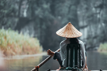 Vietnamese inhabitant on a traditional boat