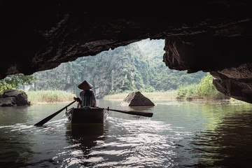 Vietnamese inhabitant on a traditional boat
