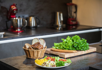 Omelet with herbs and vegetables on a gray table