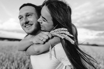 Young couple in love outdoor.Stunning sensual outdoor portrait of young stylish fashion couple posing in summer in field