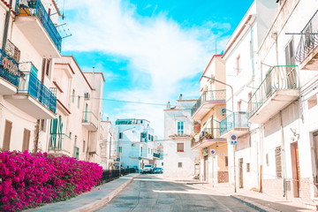 The narrow streets of the island with blue balconies, stairs and flowers.