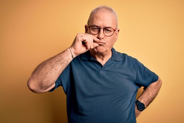 Middle age handsome hoary man wearing casual polo and glasses over yellow background mouth and lips...