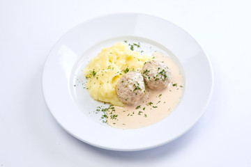 meatballs with mashed potato on the white plate
