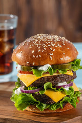 Big sandwich - hamburger burger with beef, tomato, cheese, pickled cucumber and red onion.