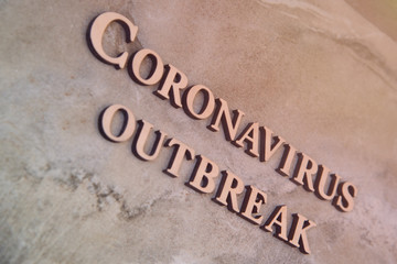 coronavirus outbreak word written on wooden letters.