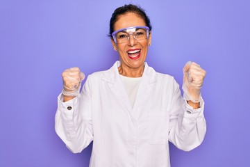 Middle age senior scientist woman wearing coat and laboratory glasses over purple background...
