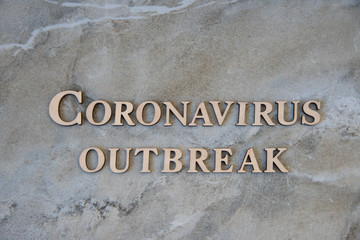 coronavirus outbreak word written on wooden letters.