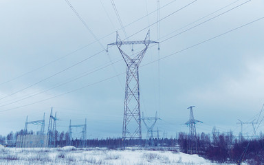 Electric transmission line at snowy road at winter Rovaniemi