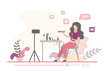 Female beauty blogger making review for cosmetics. Online video stream. Woman on workplace, tripod with smartphone.